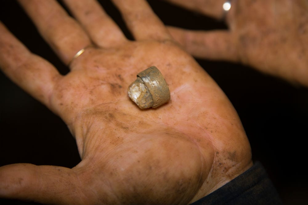 A silver ring containing an accumulation of crystal that was apparently formed inside the stalactite cave. (Photo: Shmuel Magal/ IAA)