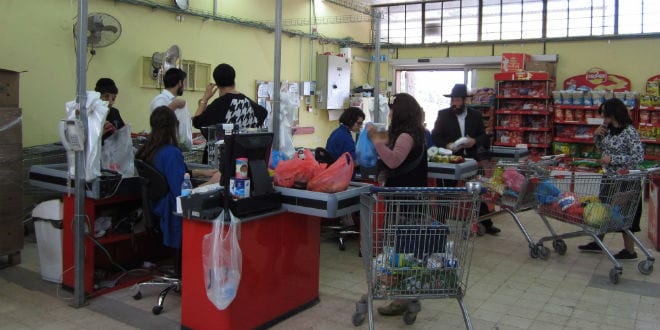 Store patrons check out at the Colel Market. (Photo: Tsivya Fox/IsraelMediaNetwork)