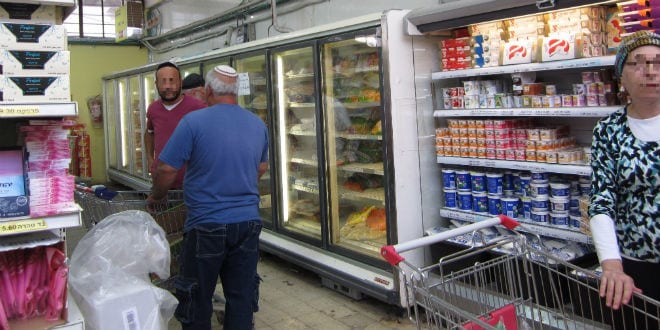 Patrons shop at Colel Chabad Market in Safed. (Photo: Tsivya Fox/IsraelMediaNetwork)