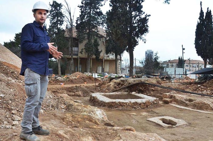 Excavation director, Alex Wiegmann, alongside the complex winery. Different flavor wines were probably produced in it. (Photo: Israel Antiquities Authority./JNi Media)