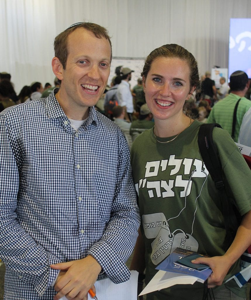 Rabbi Tuly Weisz of Israel365 presenting a gift bag to the 50,000 immigrant to Israel Rebecca Glanzer. (Courtesy)