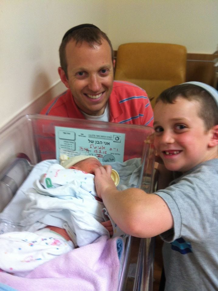 Big brother Dovid welcomes his new sibling to the family. (Photo: Tuly Weisz)