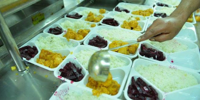 Preparing meals to be given to needy families. (Photo courtesy of Colel Chabad)