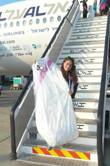 Ilana Barta arriving in Israel, wedding dress in hand, July 22, 2014. (Photo: Shahar Arzan)