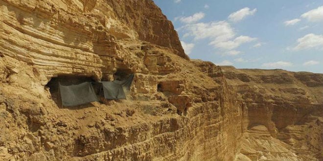 The cave where the archaeological excavation is being conducted is situated c. 80 meters from the top of the cliff and c. 250 meters above the base of the canyon. (Photo: Guy Fitoussi, courtesy of the IAA Unit for the Prevention of Antiquities Robbery)