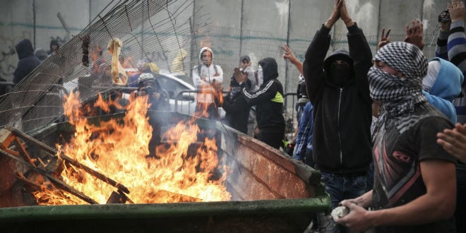 Palestinian youth clash with Israeli Border Police at the entrance to the Shuafat refugee camp, following the driving terror attack in Jerusalem by a resident of the camp. The Shuafat man drove his car into a crowd of people waiting by the Shimon Hatzadik lightrail station in Jerusalem injuring at least 8 people, and killing at least one bystander. The driver was shot and killed near the site of the attack. November 05, 2014. (Photo: Hadas Parush/FLASH90)