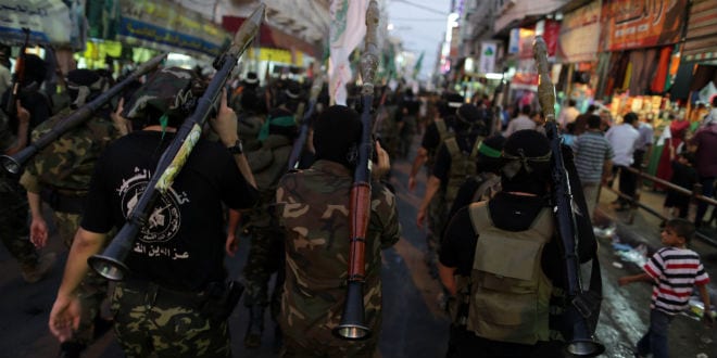 Masked Palestinian members of the Ezz Al-Din Al Qassam militia, the military wing of Hamas, hold their weapons during a march in Gaza City, September 14, 2013. (Photo: Wissam Nassar/FLASH90)