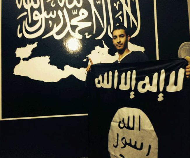 Karim Abu-Salah, ISIS flag in the background. (Photo: Israel Security Agency)
