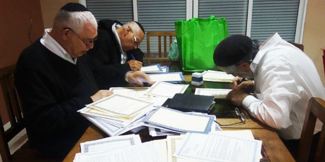 Rabbis pore over conversion and marriage documents (Ketubot) for Malagasy Jews. (Photo: Barbara Vinick/Kulanu)