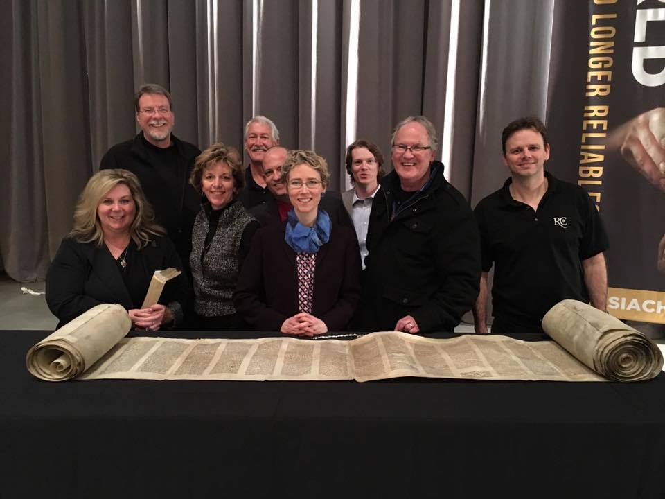 Ratio Christi organization members with the Torah scroll. (Ratio Christi Facebook Page)