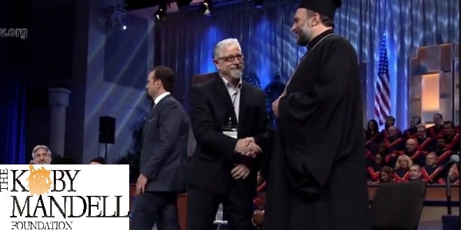 Rabbi Seth Mandell, head of the Kobi Mandell Foundation shakes hands with Father Gabriel Naddaf of the Israeli Christian Recruitment Forum. (Photo: Screenshot)