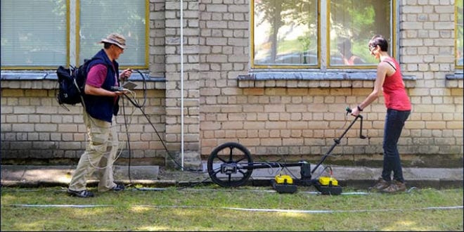 Prof. Harry Jol & Nicole Awad conducting a Ground Penetrating Radar survey at the site of the Great Synagogue of Vilna in Lithuania. (Photo: Jon Seligman/ Israel Antiquities Authority)