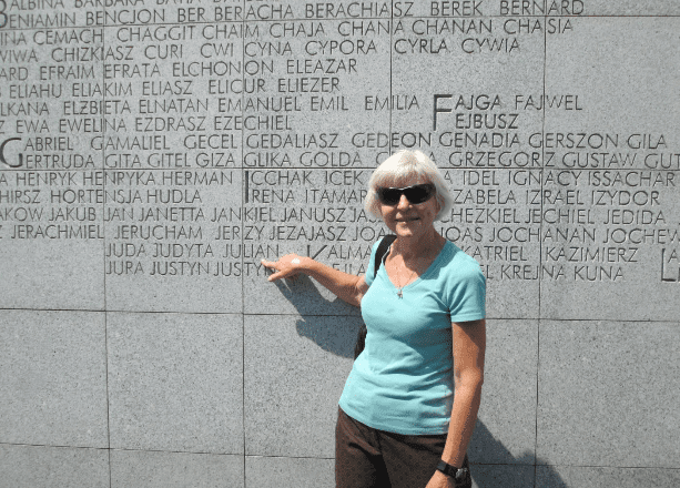 Erica points to her family name ‘Julian’ on the Ungshlagplatz memorial. (Photo: Breaking Israel News)