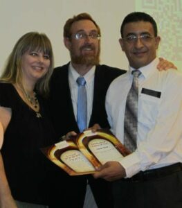 Yehudah Glick and Mendi Safadi present a "Caller of Zion" award to Jane Kiel. (Photo: Tsivya Fox/Breaking Israel News)